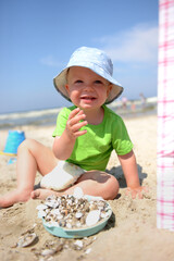 boy on the beach with seashells