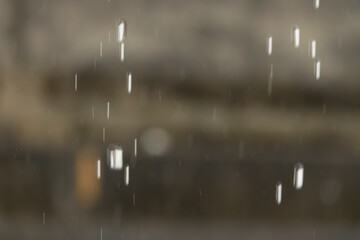 Rain falling from the sky, creating a blurry and hazy effect. The raindrops are scattered all over the scene, giving it a sense of movement and energy. Scene is one of tranquility