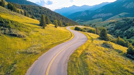 Fototapeta premium Sunset over winding mountain road with vibrant colors reflecting on the horizon during autumn season
