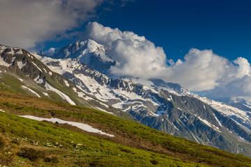 Tour du Mont Blanc beautiful landscapes in the Alps mountains on a sunny summer day. Green grass on...