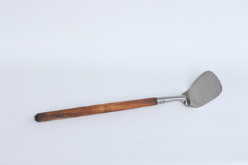 Stainless steel kitchen wok spatula isolated on white background.