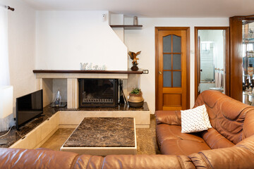 Inviting living room with fireplace, leather sofa, tv, and marble coffee table for a cozy and comfortable ambiance