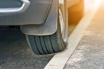 Wheel on curb, traffic violation. Parked car with one wheel on curb. Bad driver, poor driving,...