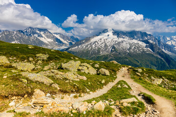 Tour du Mont Blanc beautiful landscapes in the Alps mountains on a sunny summer day. Green grass on...
