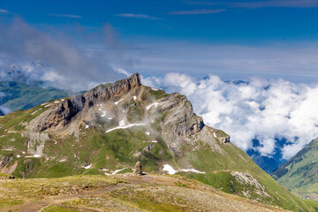 Tour du Mont Blanc beautiful landscapes in the Alps mountains on a sunny summer day. Green grass on...