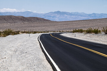 Straight empty road in Death Valley National Park , Nevada , USA