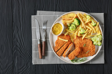 breaded pork cutlet with fries, broccoli on plate