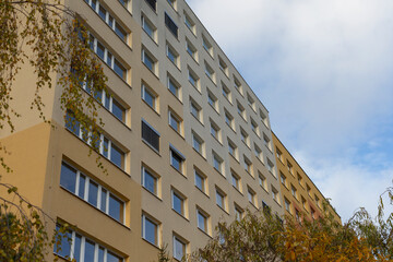 This apartment building showcases multiple windows against a clear sky, highlighting its charm and design