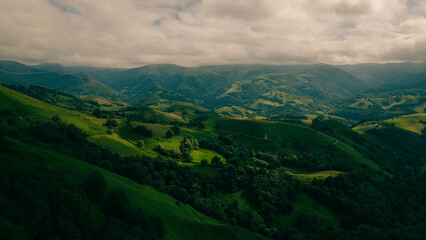 Fototapeta premium A breathtaking view of lush green hills unfolds, capturing the serenity of the French Pyrenees on the Camino de Santiago.
