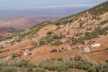 Atlas Mountains landscape in Morocco with houses in traditional vernacular architecture style. Adobe, stone and wood