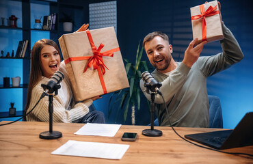 New year is coming, with gift boxes. Radio hosts recording podcast