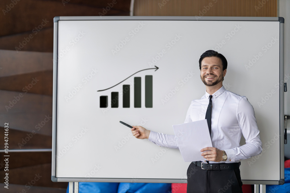 Poster a man is standing in front of a white board with a graph on it. he is holding a piece of paper and s