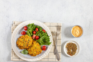 pumpkin carrot potato patties on plate, top view