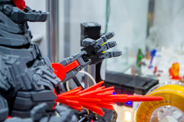 Art object printed on 3D printer. Robot toy created on 3D printer. High-precision 3D printing technologies. Creation of three-dimensional models. Modern new innovative technology.