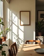 A cozy and bright living room with a large window, a wooden table, and a framed wall decor. The room has a warm and inviting atmosphere with natural light and potted plants