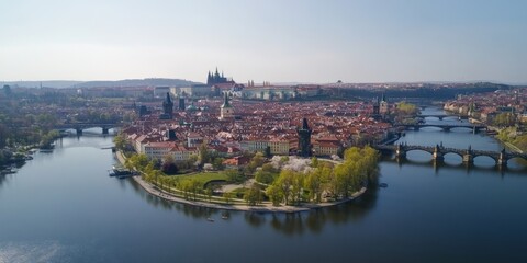 Fototapeta premium Prague's Old Town, seen from above in spring, shows the Charles Bridge arching over the Vltava River. The castle is visible in the distance.