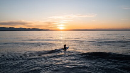 Fototapeta premium A lone surfer effortlessly navigates a gentle wave during a serene sunset, blending harmony with nature and the rhythm of the sea.