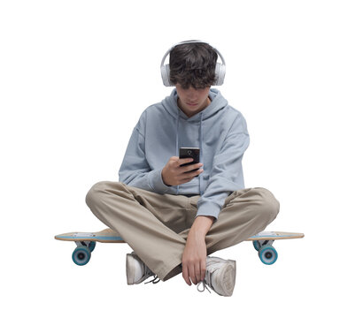 Skater sitting and using a smartphone