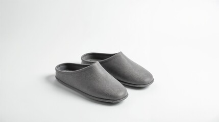 Cozy gray slippers placed on a minimalist backdrop showcasing comfortable indoor footwear for relaxation