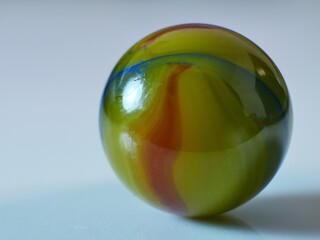 Closeup on a colorful multicolored marble on a white background