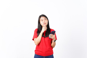 beautiful Asian woman, deep in thought, looks upward while holding a smartphone, set against a white background