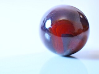 Closeup on a colorful multicolored marble on a white background