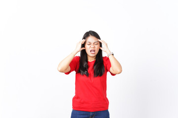 beautiful Asian woman holds her head in pain, expressing a headache, against a white background