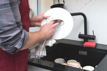 Top view of a man washing dishes. Cleaning and housekeeping concept	