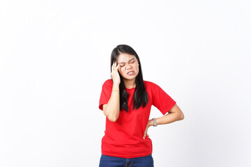beautiful Asian woman holds her head in pain, expressing a headache, against a white background