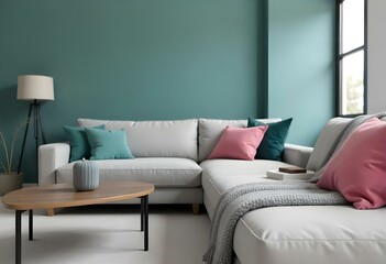 A modern living room with a large gray sofa with pink and teal throw pillows, a gray blanket, and a teal wall in the background