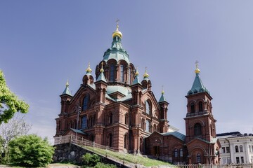 Uspenski Cathedral in Helsinki, Finland, under a clear blue sky