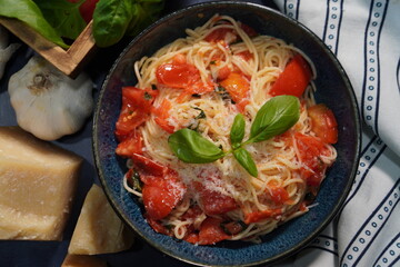 A classic Italian pasta dish, Capellini Pomodoro with fresh tomatoes, basil and garlic. Making an Italian meal for dinner using fresh ingredients from the garden.