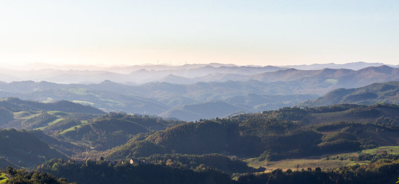 View of the hills of Montefeltro in Italy, from the Pietrarubbia region under the Carpegna Mount in the Italian Marche, close to Emilia Romagna and Toscana. Wind turbines appear in the background.