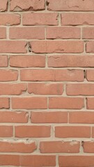 Obraz premium Rough and weathered red brick texture with uneven surface and visible grooves, material