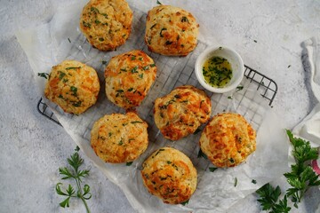 Homemade cheddar biscuits topped with garlic butter and parsley