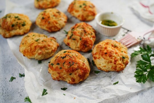 Homemade cheddar biscuits topped with garlic butter and parsley