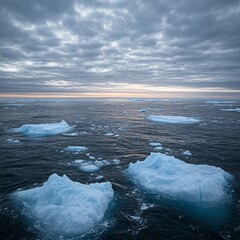 Obraz premium Calm Arctic Scene with Icebergs and Cloudy Sky