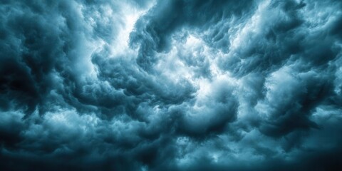 Obraz premium Dramatic clouds swirl in a moody sky, capturing the essence of nature's unpredictability and beauty.