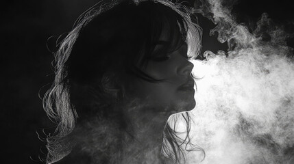 A woman stands in profile, enveloped in swirling smoke, creating a mysterious and artistic atmosphere during a studio photoshoot at night