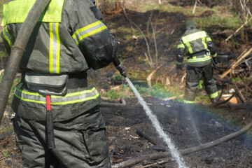 Lifeguard on duty. Firefighter puts out fire. Details of fire. Rescuer in Russia.