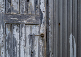 An old wooden door in the fence is a close-up.