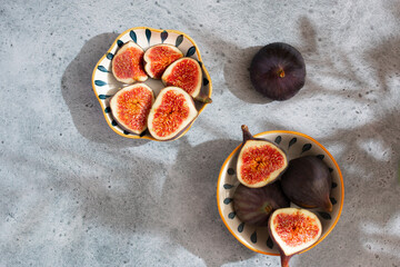 Sliced figs in a porcelain plate on the table. Top view