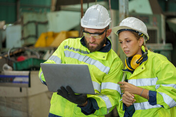 caucasian industrial Engineer manager man wearing eyeglass and helmet discussion with mechanic...