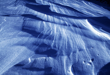 Artistic image made in velvia 50asa slide that portrays snow photographed against the sun that creates strong contrast effects with underexposed blue tones