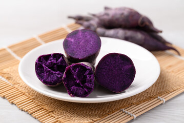 Steamed purple sweet potatoes on plate ready to eating