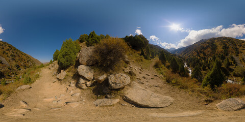 Full Spherical panorama of rocky hiking trail trough picturesque mountain valley at sunny autumn...