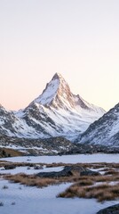 A breathtaking mountain peak rises majestically, covered in snow and bathed in the warm light of sunrise, surrounded by serene valleys