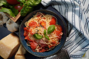 A classic Italian pasta dish, Capellini Pomodoro with fresh tomatoes, basil and garlic. Making an Italian meal for dinner using fresh ingredients from the garden.