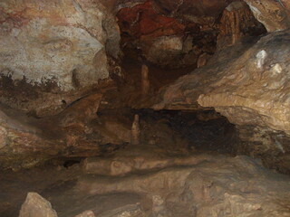 Stalagmites growing inside a dark cave