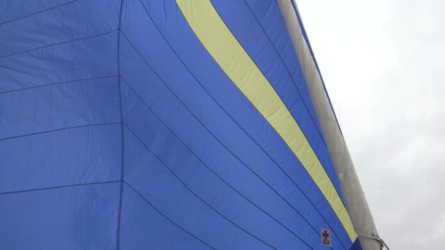 footage of a spinnaker and spinnaker handling on a modern sailboat